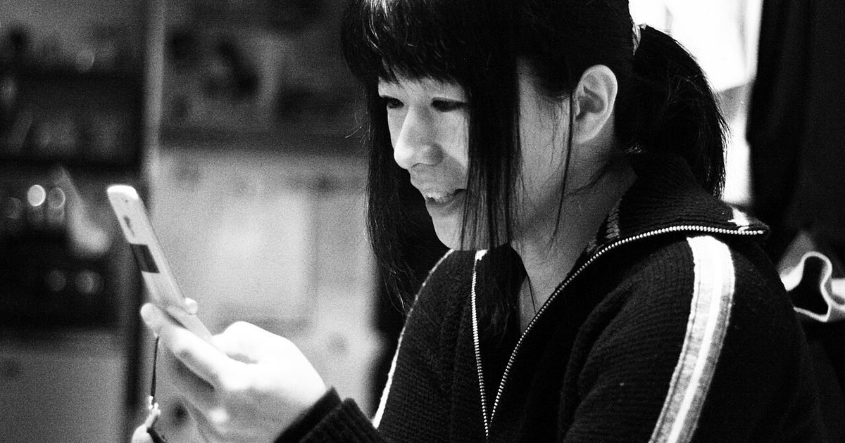 Person using a smartphone, illustrating a permission review on Android