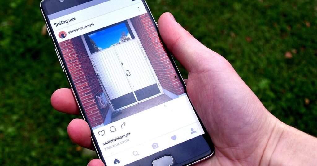 A hand holding a smartphone with a social app open, used to illustrate phone privacy choices.