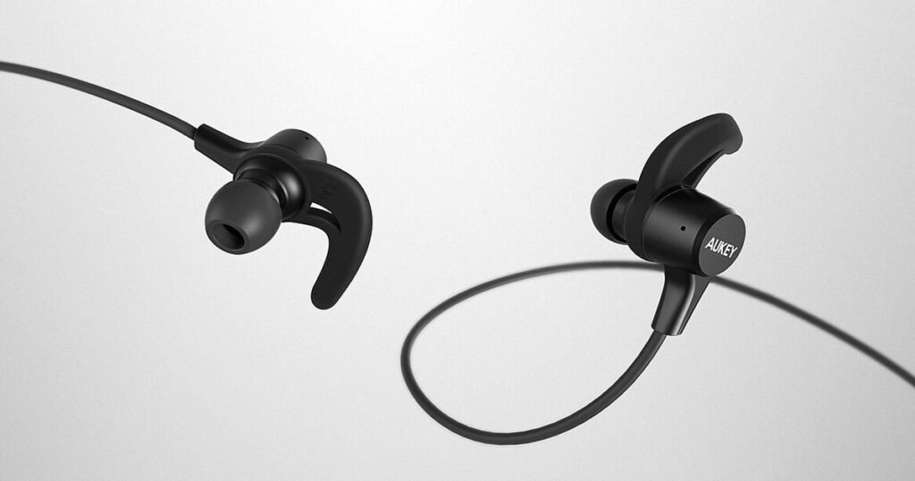 Pair of black wireless earbuds on a white background