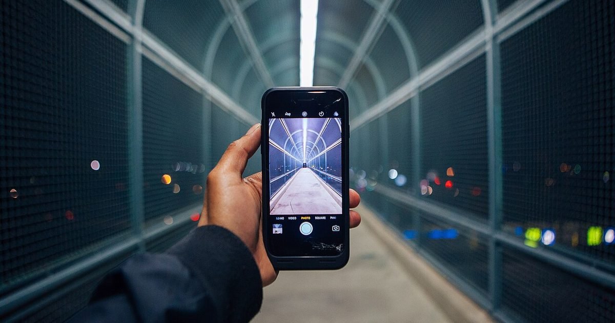 Phone camera app framing a night walkway with lights