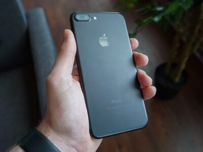 Hand holding a smartphone, used as the featured image for a phone privacy settings guide
