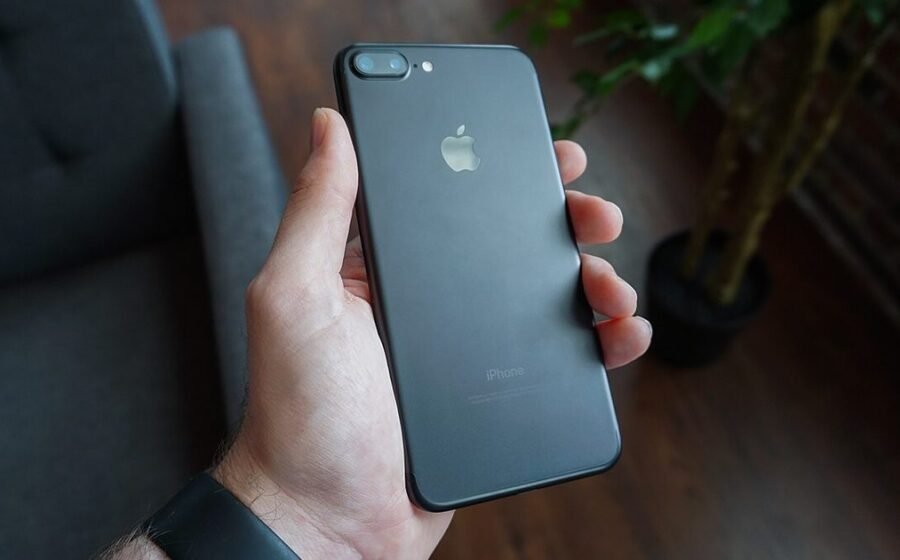 Hand holding a smartphone, used as the featured image for a phone privacy settings guide