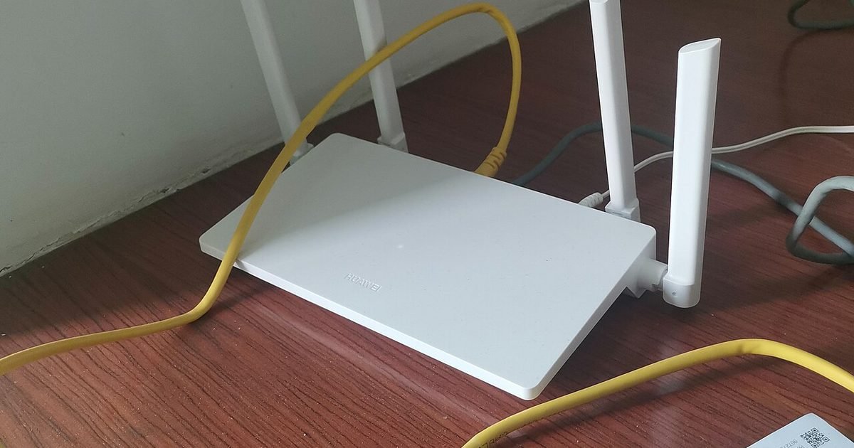 Home Wi-Fi router placed on a desk with Ethernet cable
