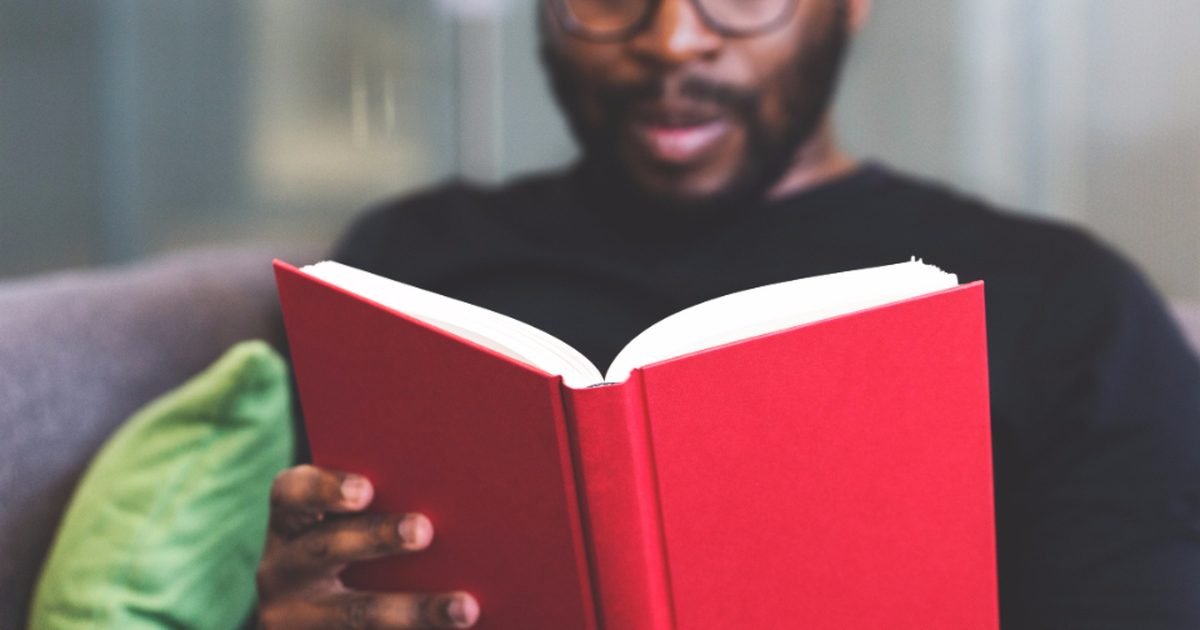 Student reading a book for a comprehension check study routine