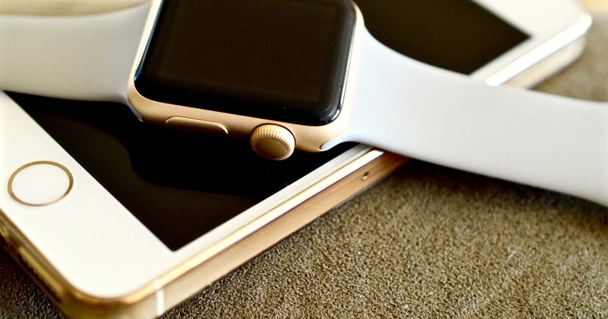 A smartwatch and a phone resting together, the phone a Bluetooth-calling watch stays tethered to