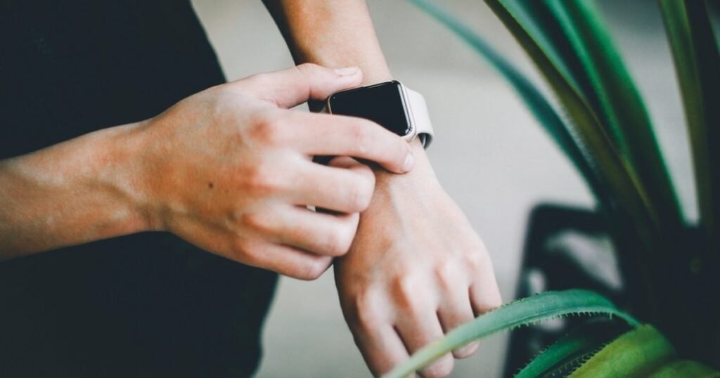 Hands fastening a smartwatch on a wrist, the kind of watch this guide checks for call support