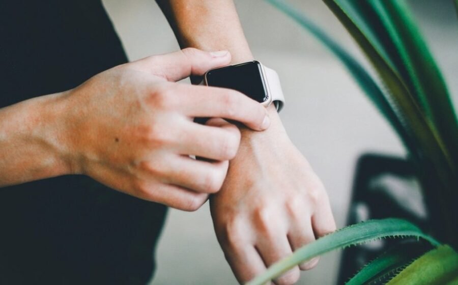 Hands fastening a smartwatch on a wrist, the kind of watch this guide checks for call support