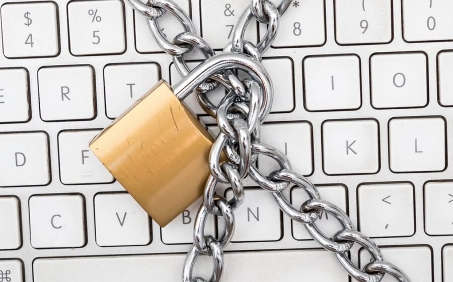 Padlock and chain over a keyboard, used to illustrate password manager security