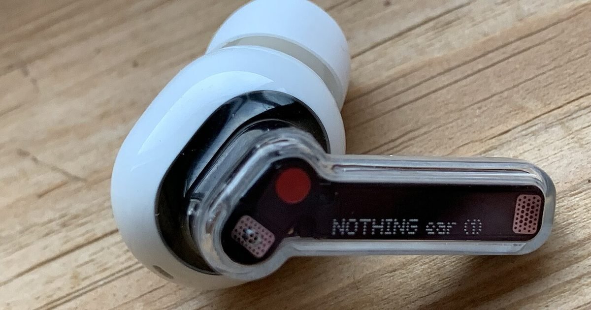 Close up of a single wireless earbud for pairing and reset checks
