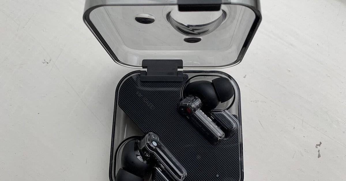 Wireless earbuds in an open charging case for contact checks